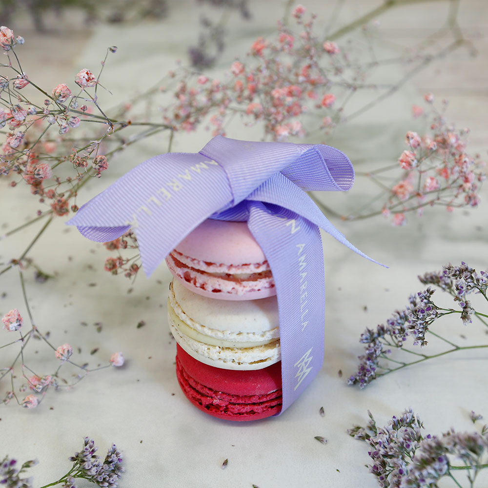 One Tahini Grenade, one Vanilla and one Raspberry macaron cakes wrapped with Maison Amarella ribbon